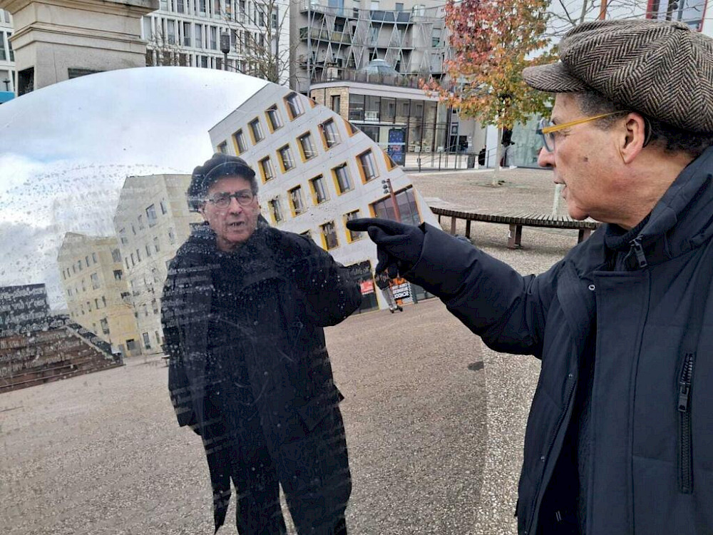 Director Malek Kellou stands in front of the anti-monument entitled “Table de désorientation”, which was unveiled on 6 November at Place de Padoue in Nancy, France. © Baptiste Coulon / RFI